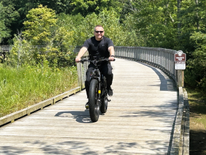 Man riding electric bicycle on path